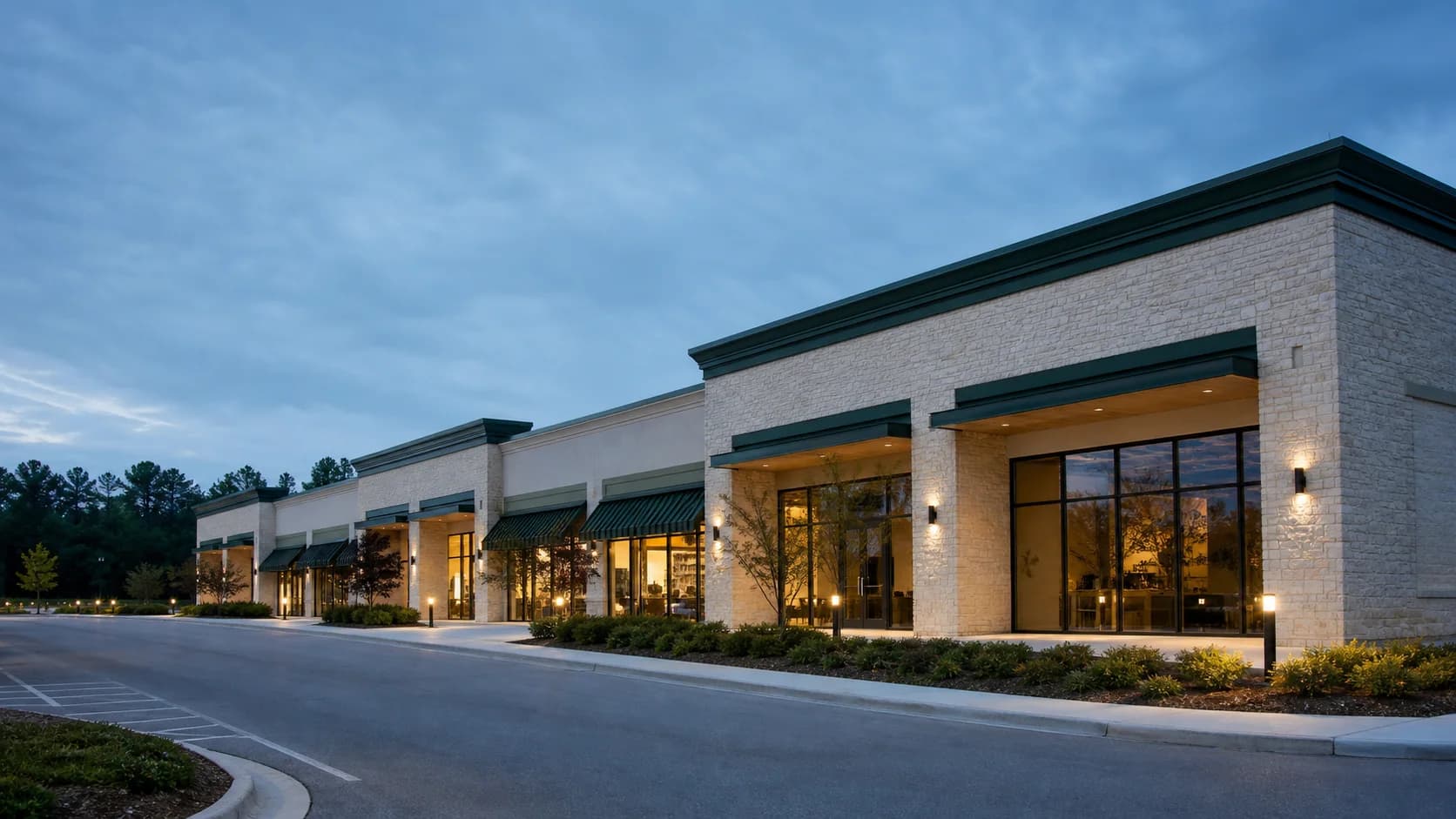 Representative eight-storefront neighborhood retail center at blue hour